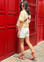 embroidered linen shirt band collar button placket close-up