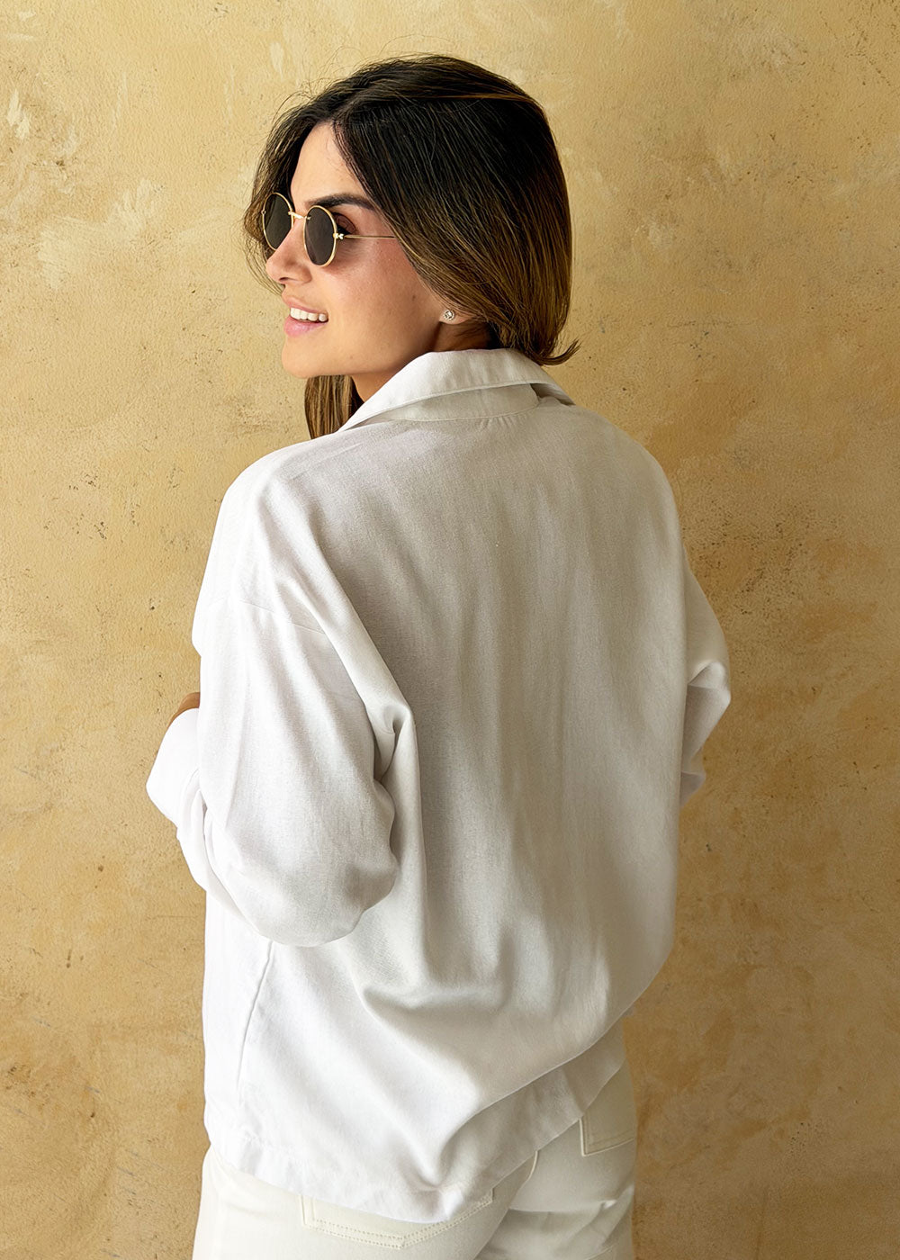 ivory linen shirt cuffed sleeve close-up