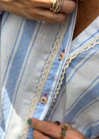 blue striped poplin long-sleeve shirt, model in natural light