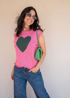Pink acrylic knit vest with round neck and contrast green heart motif at the chest, view 6