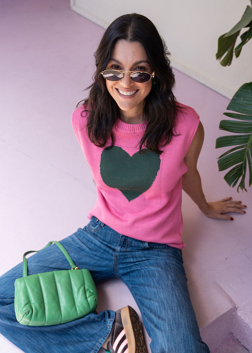 Pink acrylic knit vest with round neck and contrast green heart motif at the chest, view 5