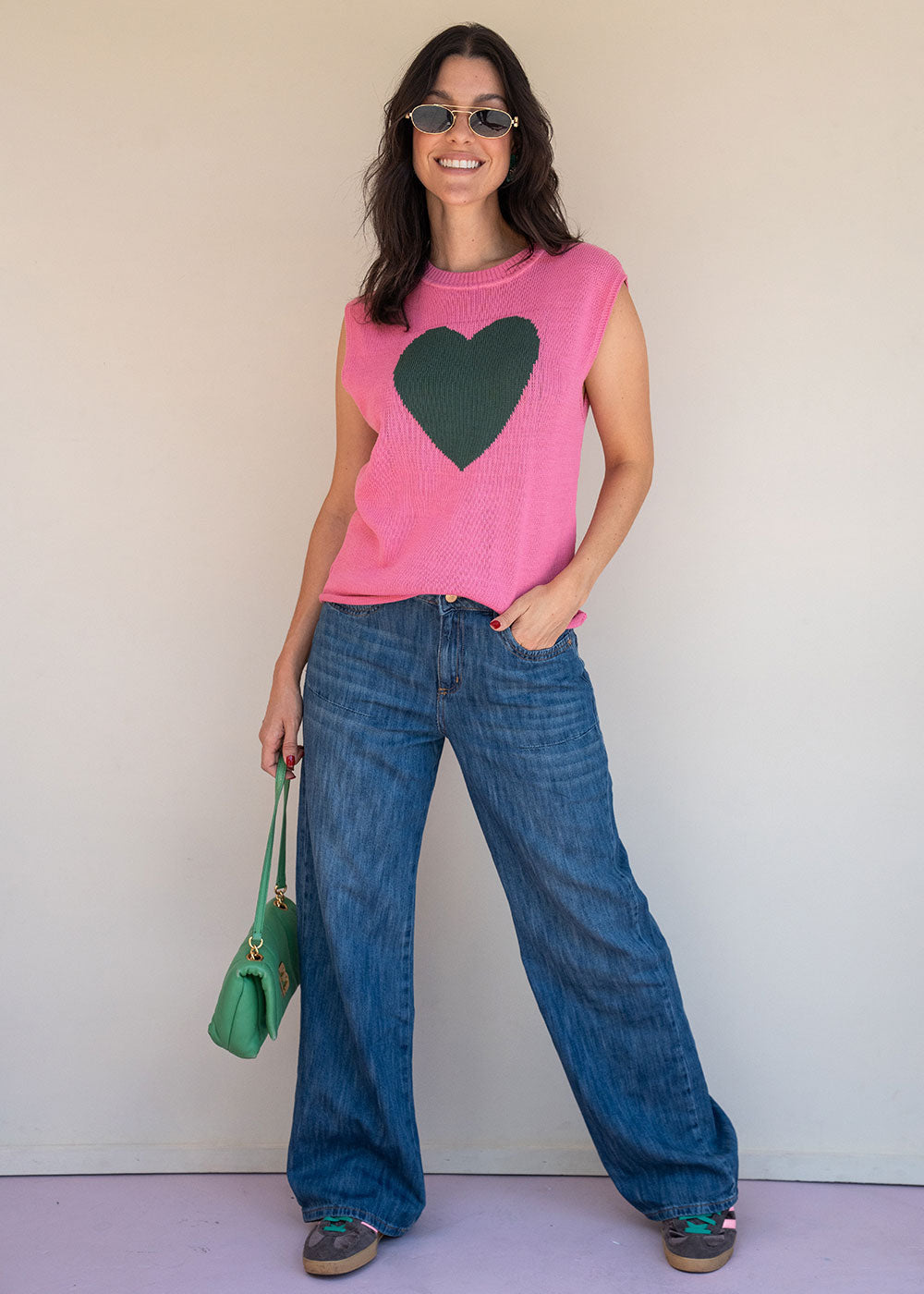 Pink acrylic knit vest with round neck and contrast green heart motif at the chest, view 4