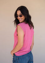 Pink acrylic knit vest with round neck and contrast green heart motif at the chest, view 7