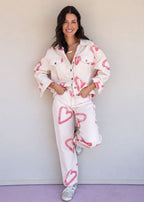 Ivory cotton drill jean with all-over red heart print, wide leg, side cuts, and knee darts, view 7