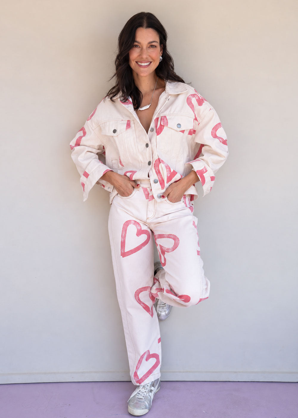Ivory cotton drill jean with all-over red heart print, wide leg, side cuts, and knee darts, view 7