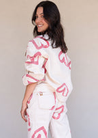 Ivory cotton drill denim jacket with all-over red heart print, front pockets, and barrel sleeves, view 4