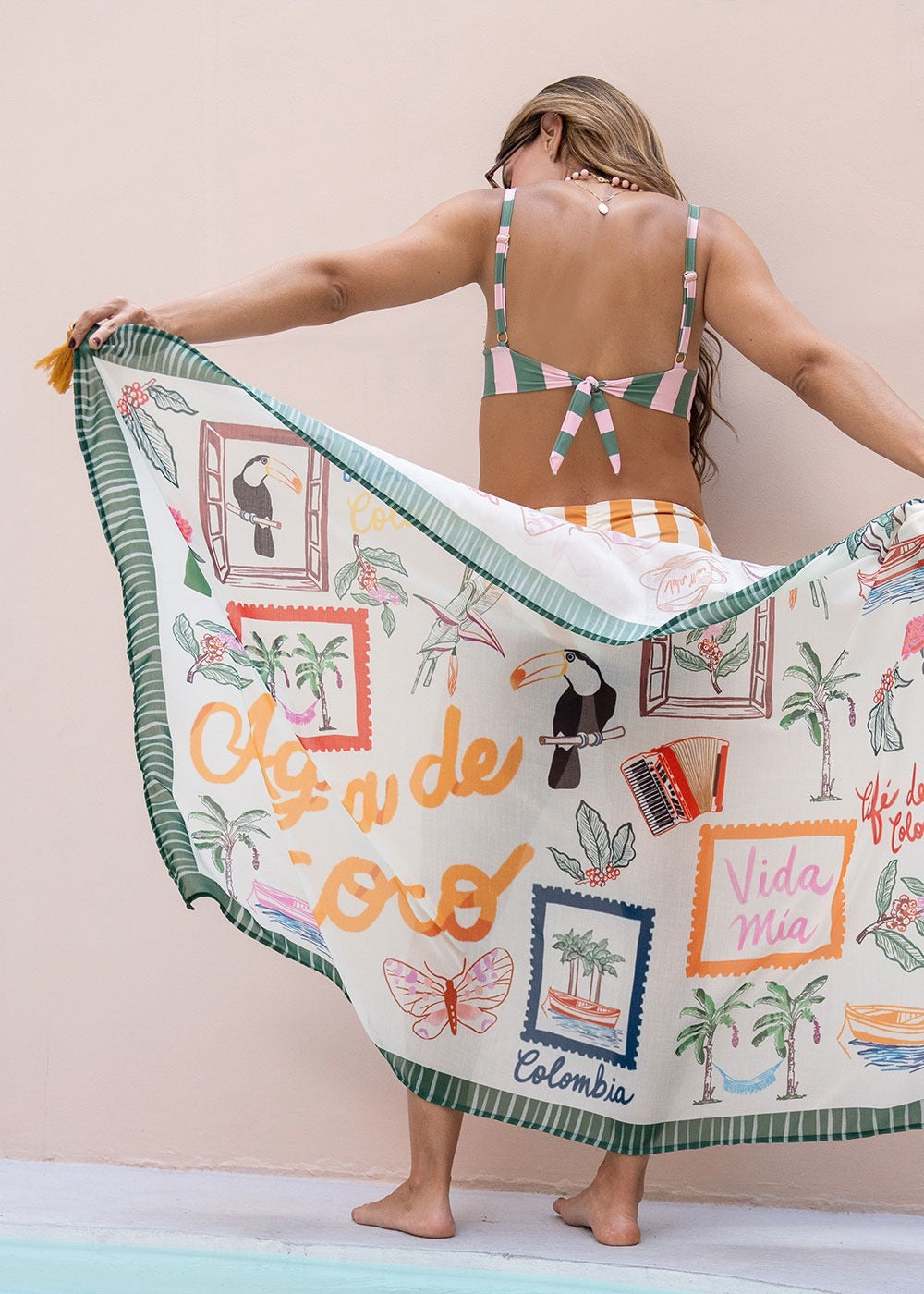 Green printed sarong styled as a body wrap on model