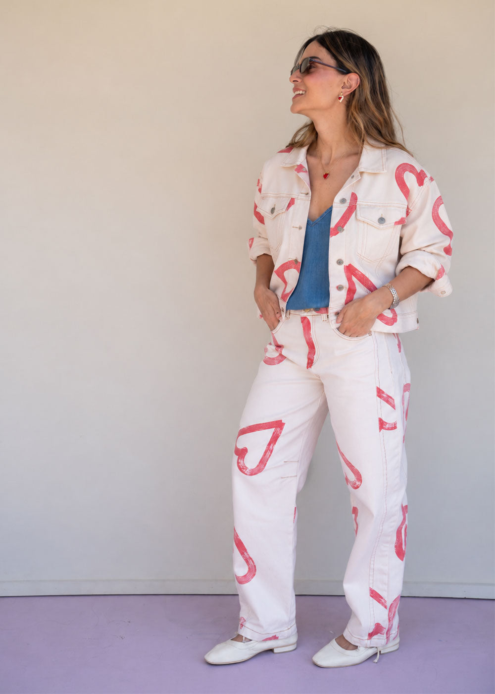 Ivory cotton drill jean with all-over red heart print, wide leg, side cuts, and knee darts, view 4