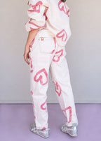 Ivory cotton drill jean with all-over red heart print, wide leg, side cuts, and knee darts, view 6