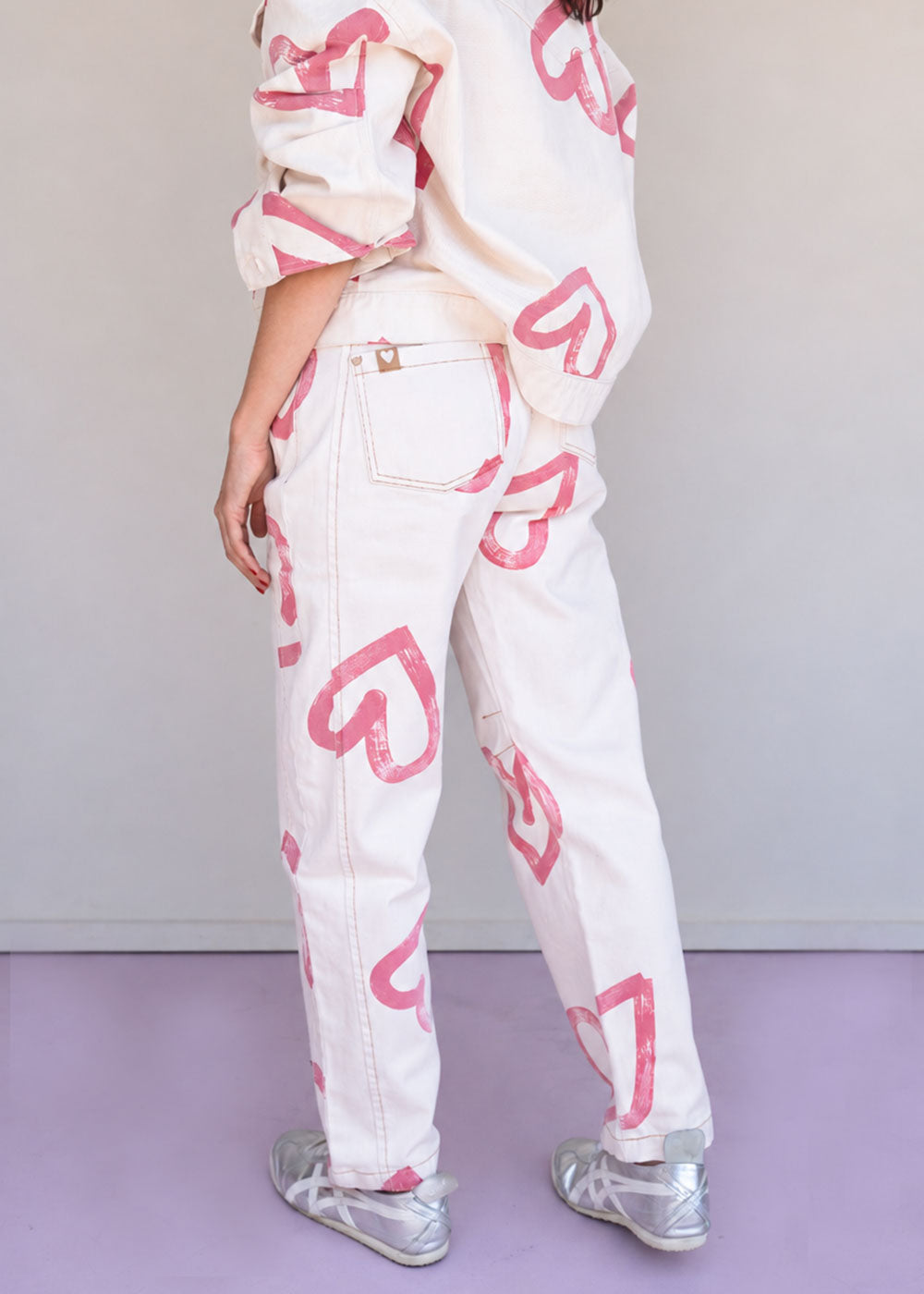 Ivory cotton drill jean with all-over red heart print, wide leg, side cuts, and knee darts, view 6
