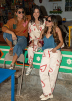 Ivory cotton drill jean with all-over red heart print, wide leg, side cuts, and knee darts, view 2