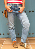 Washed indigo denim jean with belt loops, functional pockets, side cuts, and knee darts
