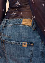 Rigid indigo denim jean with belted waistband, straight leg, and functional pockets, view 3