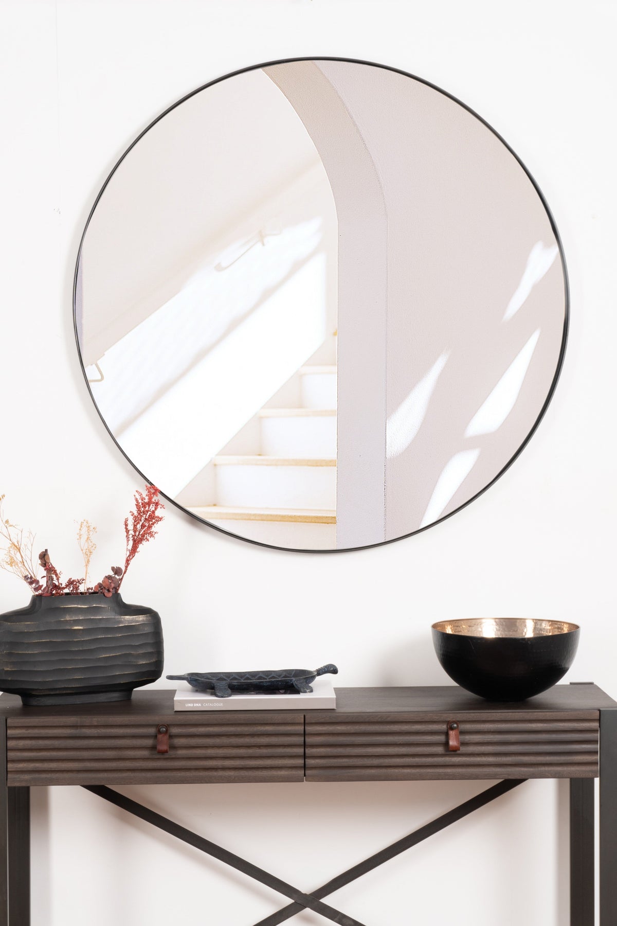 Elegant round Rotterdam mirror with a sleek steel frame, adding modern sophistication and brightness to any room.