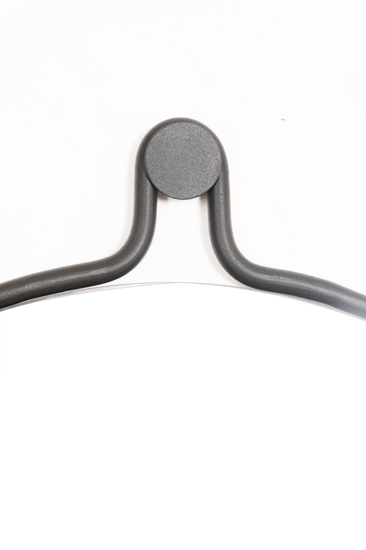 Elegant round Brussels Mirror with a unique drop-shaped design, featuring a steel frame and natural leather strap.