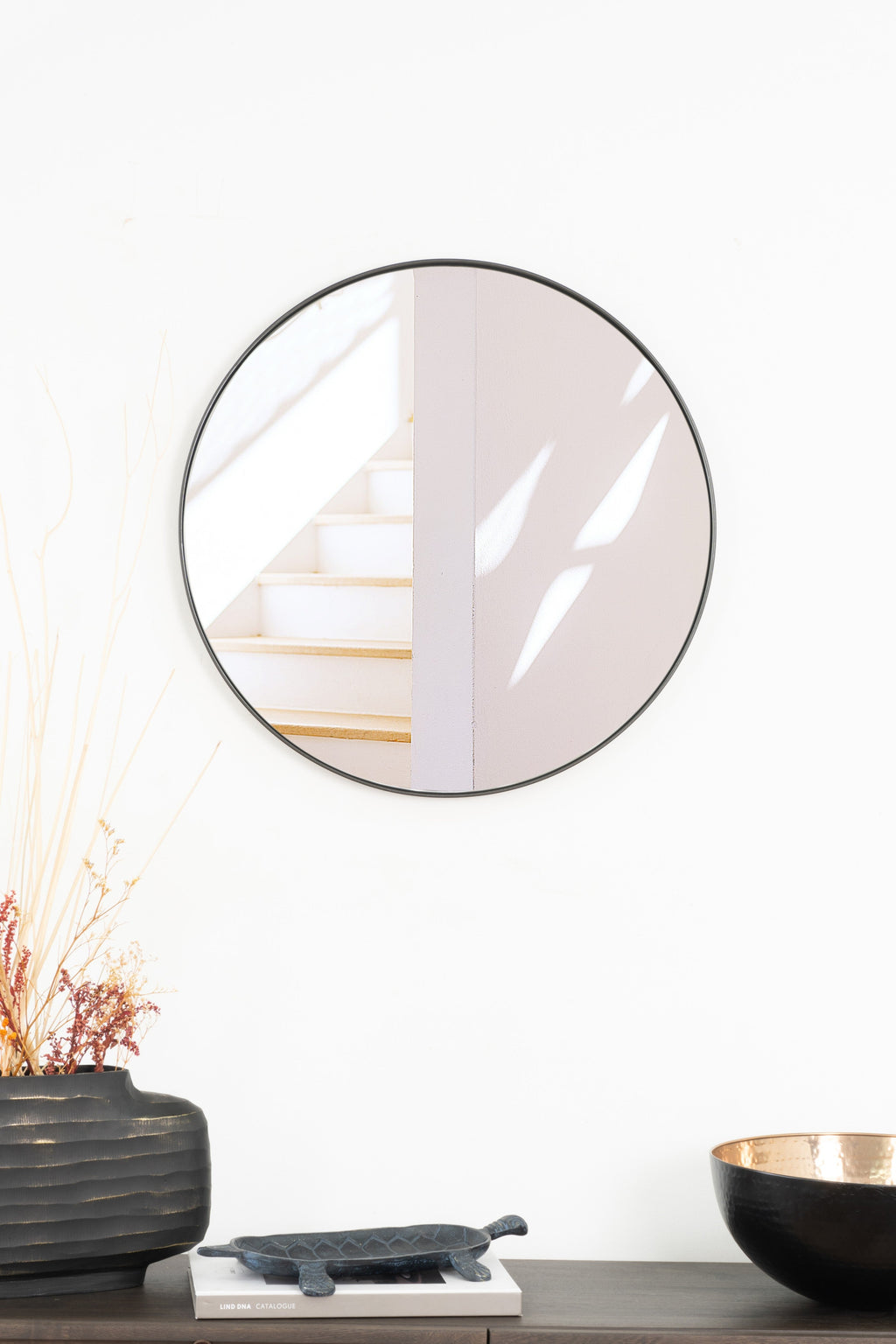 Elegant round Rotterdam mirror with a sleek steel frame, adding modern style and brightness to any room.