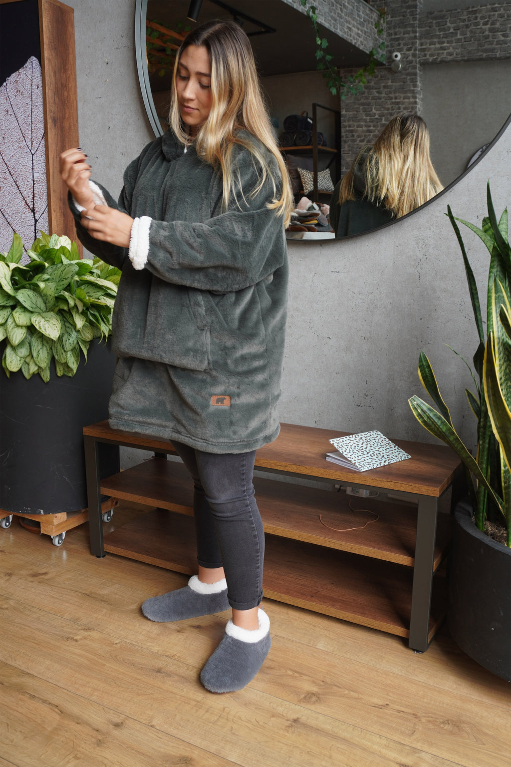 Cozy olive green teddy coat with a soft, furry texture on both sides, featuring a hood and pockets for stylish comfort.