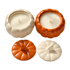Cream and orange Pumpkin Charm candles in pumpkin-shaped jars, shown with matching lids beside them.