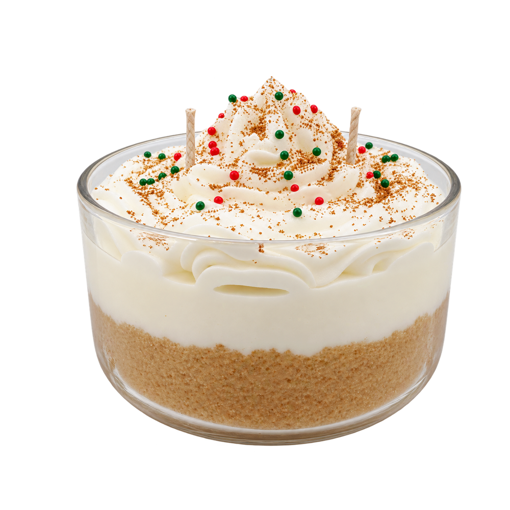 Tres Leches candle in a glass bowl, with cream-colored swirls and red and green round decorations.