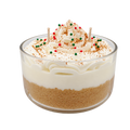 Tres Leches candle in a glass bowl, with cream-colored swirls and red and green round decorations.