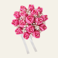 Tulip Bouquet arrangement of pink flower-shaped candles with small white flowers and a white ribbon.