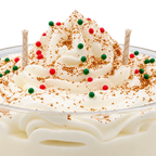 Close-up of the Tres Leches candle, showing cream-colored swirls, red and green decorations, and wicks.