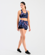 Top deportivo para mujer St. Even con soporte ligero, silueta ajustada y diseño dinámico en azul y rosa.