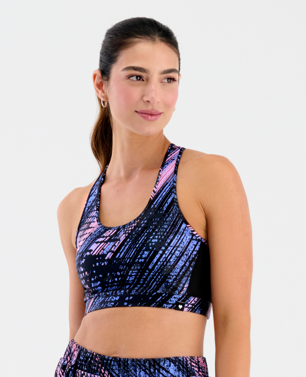 Top deportivo St. Even para mujer con soporte ligero, silueta ajustada y diseño estampado dinámico en azul y rosado.