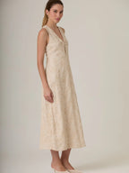 Vestido beige elegante con bordado delicado y caída suave para un look femenino.
